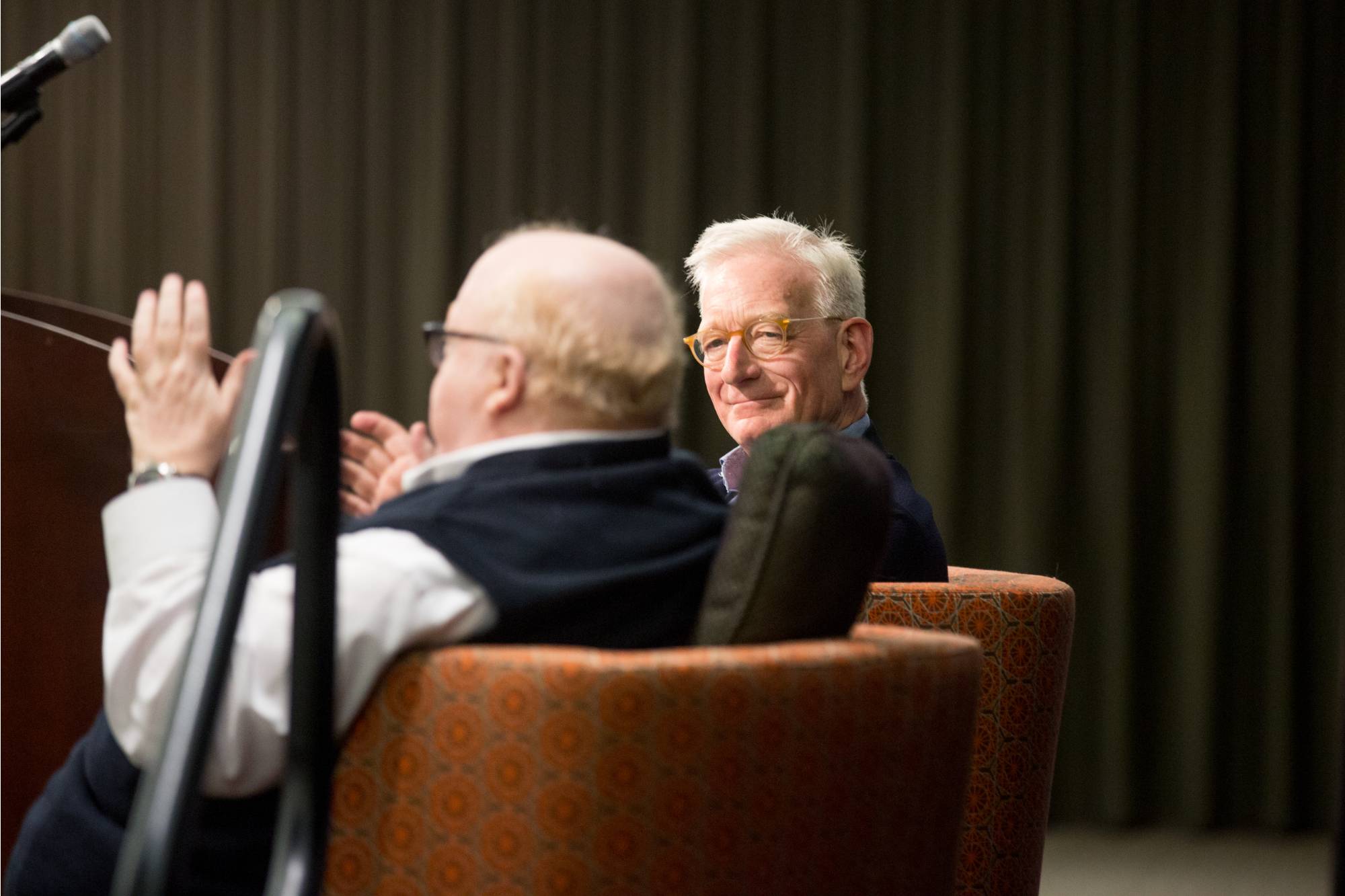 Man looking over his shoulder while sitting in chair